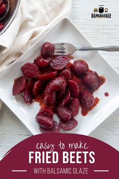 a white plate topped with beets next to a bowl of sauce and a fork