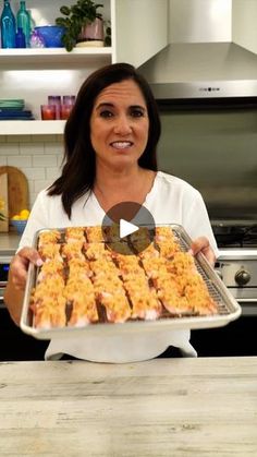 a woman holding a tray of food in her hands