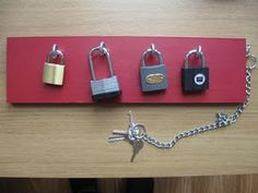 four padlocks are attached to a red board