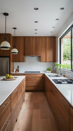 a kitchen with wooden cabinets and white counter tops, along with an island in the middle