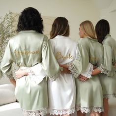 three bridesmaids in matching robes standing next to each other with their names on them