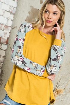 Pretty blooms pop on the raglan sleeves of a top that you'll want to pair with everything. Material: 87% polyester 10% rayon 3% spandex Stretch: Slightly stretchy Care: Machine wash cold, gentle cycle, do not bleach, tumble dry low. Made in USA Product Measurements S: 36.0-38.0” (Bust) M: 38.0-40.0” (Bust) L: 40.0-42.0” (Bust) Spring Tops With Contrast Long Sleeves, Spring Cotton Top With Raglan Sleeves, Spring Cotton Raglan Sleeve Tops, Spring Top With Long Contrast Sleeves, Spring Tops With Contrast Sleeves And Long Sleeve, Long Sleeve Tops With Contrast Sleeves For Spring, Long Sleeve Tops With Contrast Sleeves For Fall, Fall Long Sleeve Tops With Contrast Sleeves, Trendy Tops With Contrast Sleeves For Spring