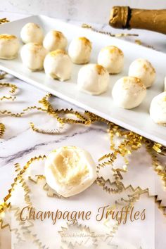 champagne truffles on a white platter with gold confetti