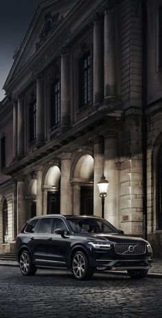 an suv parked in front of a building at night with the caption simply beautiful