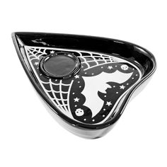 a black and white glass bowl with a spider web design on it's side