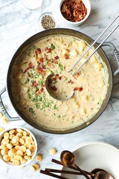 a pan filled with macaroni and cheese on top of a white marble counter