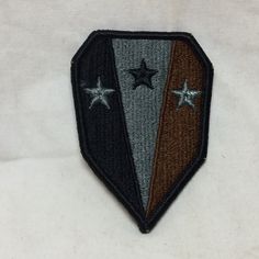 a patch with three stars on it and one is black, brown, and white