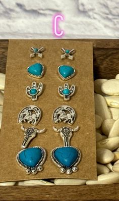 Upgrade your earring game with our Western Earring Packs! Choose from 3 unique packs, featuring stunning silver and turquoise designs and stylish studs. Now you can effortlessly add a touch of the Wild West to your look. Yeehaw! Western Earring, Blue Valentine, Western Earrings, Home Decor Sale, The Wild West, Sweatshirt Short Sleeve, Bottom Clothes, Wild West, Clutch Wallet