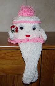 a knitted ice cream cone with a pink flower on it's head and eyes