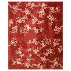 a red rug with flowers and vines on it