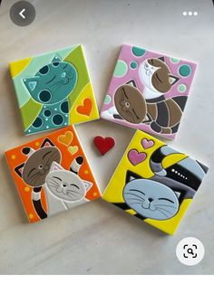 four ceramic coasters with cats and hearts on them