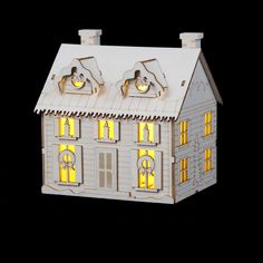 a paper model of a house with lights on it's roof and two windows