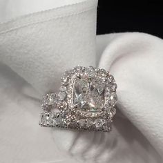 a diamond ring on top of a white cloth