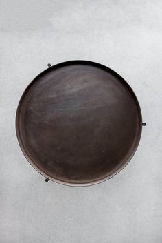 a black plate sitting on top of a white table