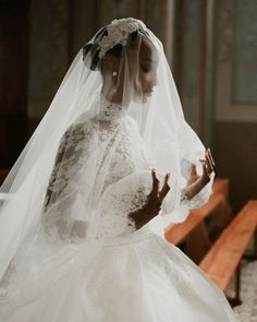 a woman in a white wedding dress and veil