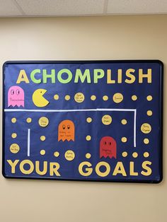 a sign that says acompplish your goals on the side of a wall