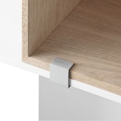 a close up of a wooden shelf with a metal handle