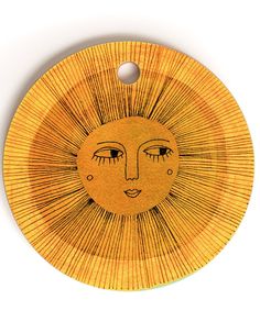 a yellow plate with a drawing of a sun on it's face and eyes