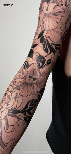 a woman's arm with flowers on it