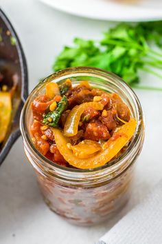 a glass jar filled with food sitting on top of a table