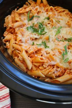 a crock pot filled with pasta and cheese