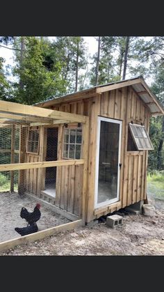 a chicken coop with an open door and windows