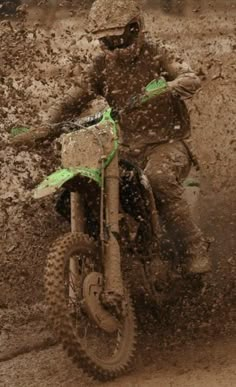 a person riding a dirt bike in the mud