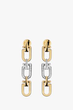 The Long Reine earrings are designed with three minimal, curved links resembling a snap hook in its most simplified form. This pair has been crafted in Italy from 18-karat yellow and white gold, with the central link set with pavé diamonds. Composition: 18-karat yellow & white gold (25g) G SI diamonds, 0.567 carats Diamonds provided by an RJC member Made in Italy Size & Fit Length: 51mm Width: 10mm Pre-Order Please expect a 3-week waiting period. Thank you for your patience. Care Always remove y Yellow Gold Diamond Earrings, Gold Jewelry Stores, Gold Diamond Earrings, Jewelry Photography, Diamonds And Gold, Engraved Logo, Fine Jewellery Earrings, Gold Jewelry Fashion, Pave Diamonds