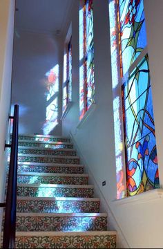 stained glass windows are on the stairs in this house