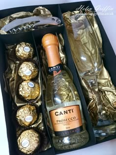 a bottle of wine and some chocolates in a box