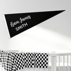 a black and white checkered flag hanging from the side of a crib