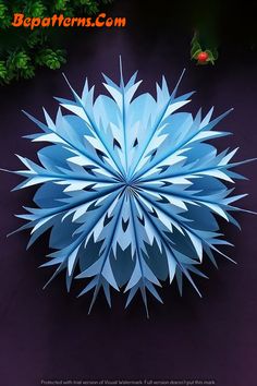 an image of a blue paper snowflake