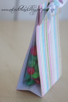 a bag filled with candy sitting on top of a wooden table