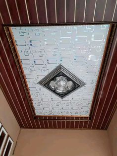 the ceiling is made up of many different types of tiles and wood, with a decorative design on it