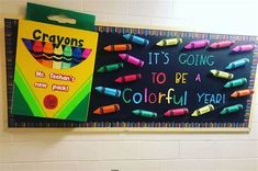 crayons are hanging on the wall next to a sign that says it's going to be a colorful year