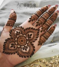 henna tattoo on the palm of a woman's hand