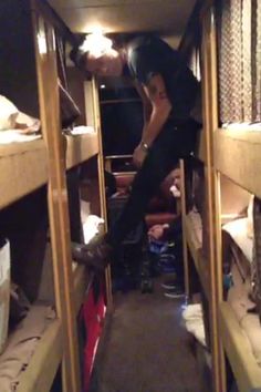 a man climbing up the side of a bunk bed