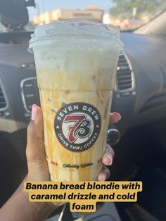 someone holding up a banana bread drink in their hand with the caption that reads, banana bread blondie with caramel drizzle and cold foam