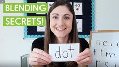 a woman holding up a sign with the words blending secrets written on it in front of her