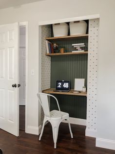 a white chair sitting in front of a desk with a computer on top of it