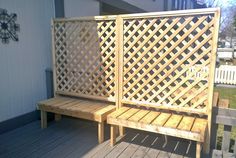 a wooden bench sitting on top of a wooden deck