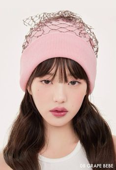 a girl with long hair wearing a pink hat