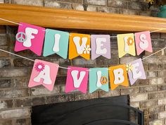 there is a sign that says five years in front of a fireplace with flowers and peace signs on it