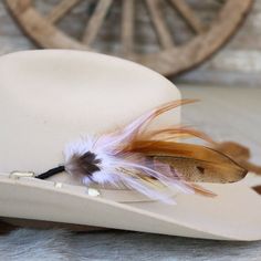 This handmade arrangement of feathers is the perfect way to set your hat apart from the rest. Simply tuck into the band of any hat. Made with a mix of pheasant tail and rooster feathers. Approximately 8 inches long, sizes may vary due to being made with natural materials.  Includes: 1 Handmade Arrangement of Feathers. How to use: Tuck into the hat band of any hat. *Each one will vary slightly due to being handmade. *Hat not included.  Natural Feathers * Approx. 8 inches - sizes may vary slightly Feathered Hat Bands For Western-themed Events, Feathered Short Brim Hat Bands For Western-themed Events, Southwestern Feather Hat Band For Country Events, Southwestern Hat Bands With Feathers For Ranch, Feathered Felt Hat With Flat Brim For Western-themed Events, Feathered Flat Brim Felt Hat For Western-themed Events, Curved Brim Hat Bands With Feathers For Western-themed Events, Western Felt Hat With Feathers For Kentucky Derby, Western-themed Felt Hat With Feathers And Flat Brim