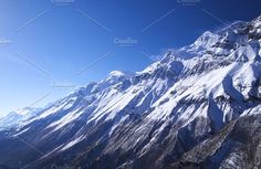 the top of a snow covered mountain