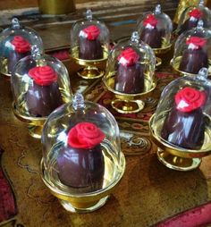 chocolate desserts with red roses under glass domes