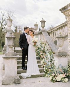 a bride and groom are standing on the stairs