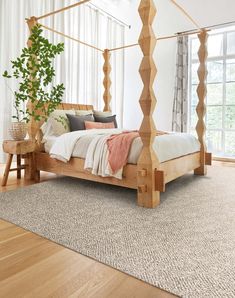 a bedroom with a wooden bed frame and white walls