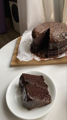 a piece of chocolate cake sitting on top of a white plate next to a knife