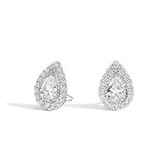 Pear Lab Created Diamond Halo Stud Earrings . These classic stud earrings feature glistening pear-shaped lab created diamonds as center stones and a dazzling lab created round diamond halo that wraps the center gem in an aura of light. Emerald Cut Diamond Earrings, Round Diamond Halo, Emerald Diamond Earrings, Diamond Earrings For Women, Halo Stud Earrings, Halo Earrings, Halo Earrings Studs, Heart Shaped Diamond, Ethical Jewelry